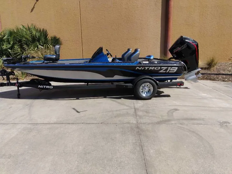 The Image of 2025 Nitro Z19 boat on trailer, parked outdoors, side view. - 0