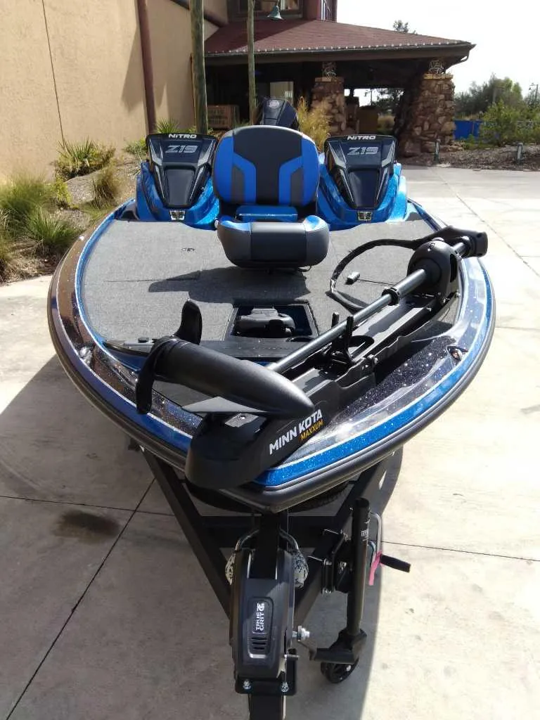 Slide: The Image of 2025 Nitro Z19 boat with Minn Kota motor, parked outdoors. - 1