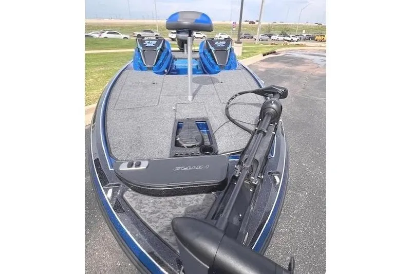 Slide: The Image of 2025 Nitro Z19 boat with dual seats and trolling motor on a paved surface. - 10