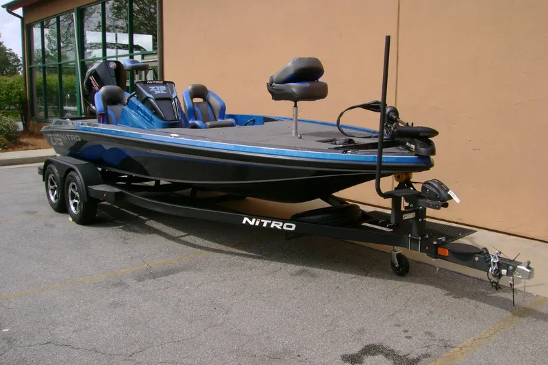 Slide: The Image of 2025 Nitro Z19 boat on trailer, parked outdoors, featuring sleek design and modern features. - 8