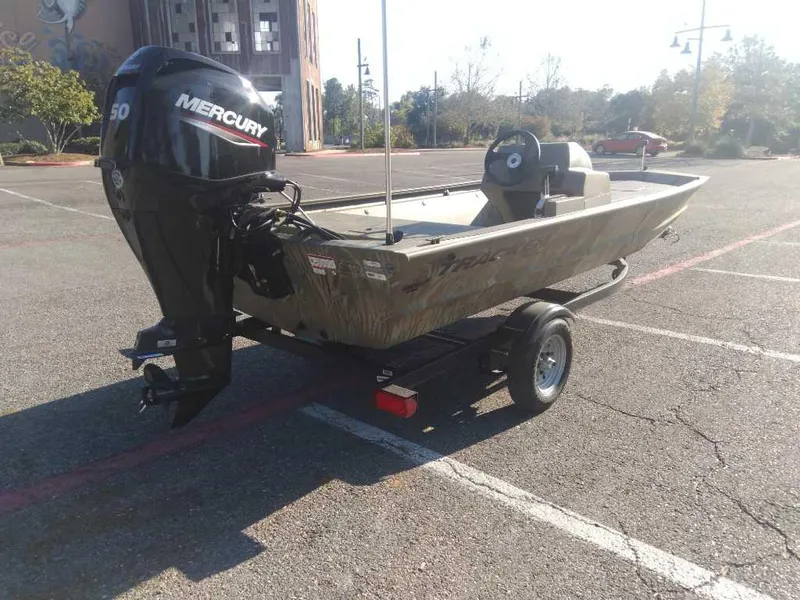 Slide: The Image of 2025 Tracker Grizzly 1648 SC boat with Mercury engine in parking lot. - 4