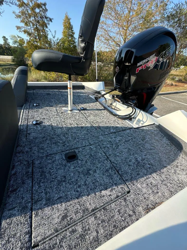 Slide: The Image of 2025 Tracker Pro Team 195 Tournament Edition boat with Mercury engine, gray deck, and seating. - 6