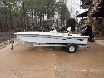 The Image of 2025 Mako Pro Skiff 17 CC boat on trailer, parked outdoors. - 0