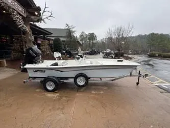 Slide: The Image of 2025 Mako Pro Skiff 17 CC boat on trailer, parked outdoors. - 2