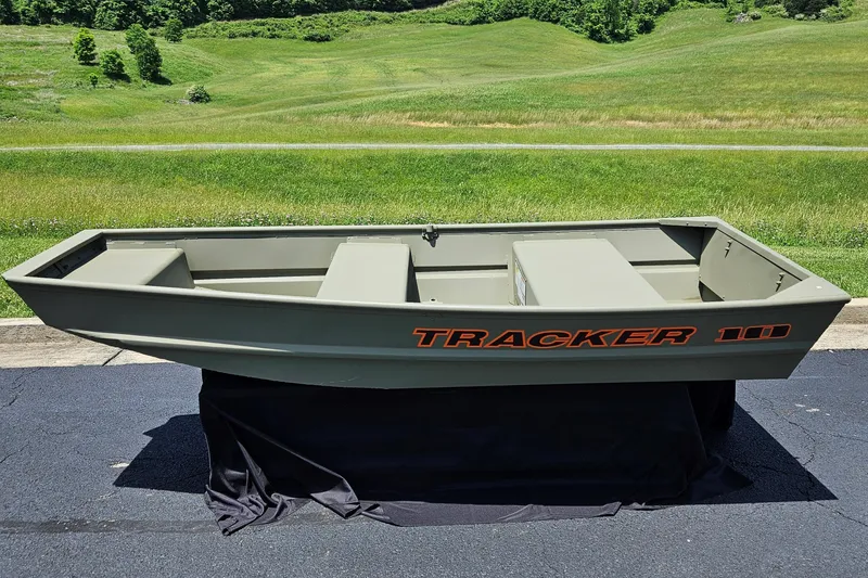 Slide: The Image of 2025 Tracker Grizzly 1036 Utility boat displayed outdoors on a sunny day. - 24