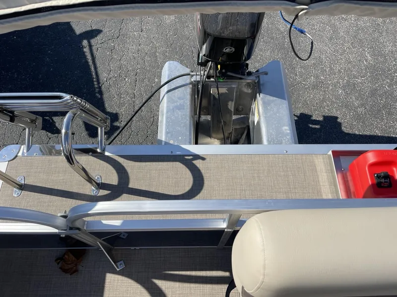 Slide: The Image of 2025 Sun Tracker Bass Buggy 16 XL Select boat deck with motor and seating. - 10