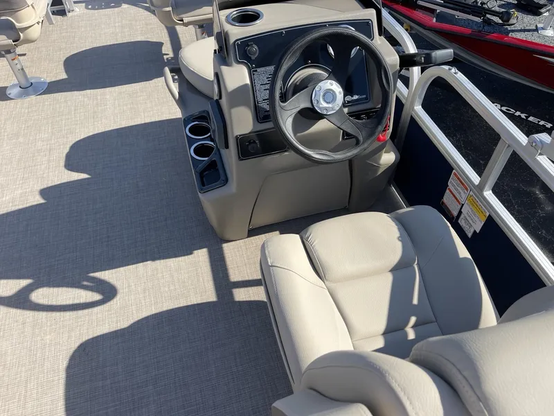 Slide: The Image of 2025 Sun Tracker Bass Buggy 16 XL Select boat interior with steering wheel and seating. - 11