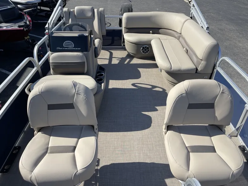 Slide: The Image of 2025 Sun Tracker Bass Buggy 16 XL Select pontoon boat with beige seating and spacious layout. - 13