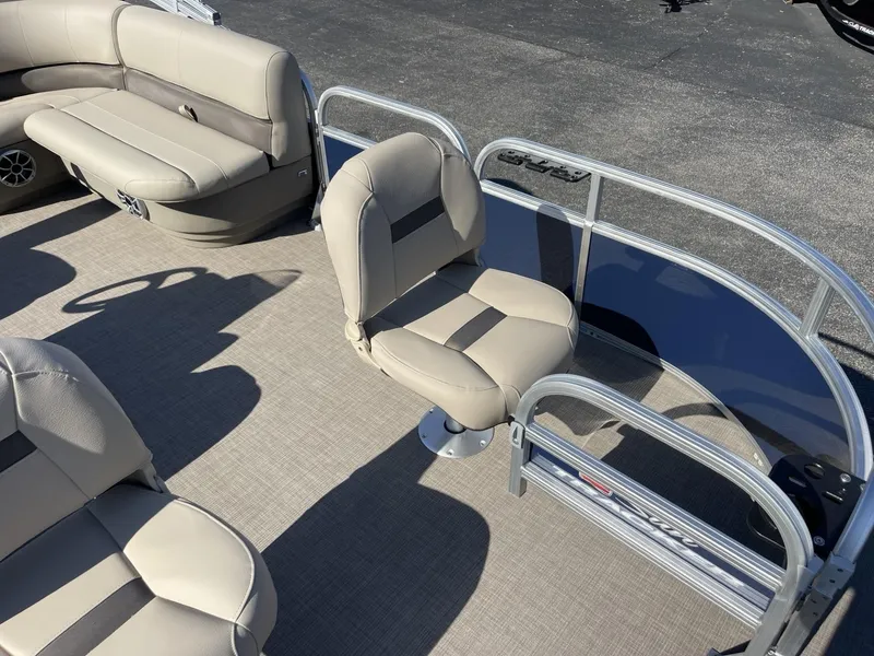 Slide: The Image of 2025 Sun Tracker Bass Buggy 16 XL Select pontoon boat interior with beige seating. - 7