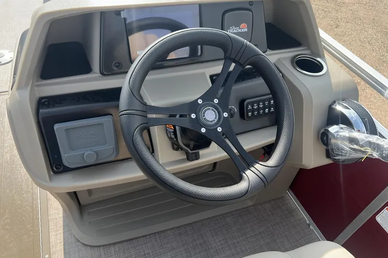Slide: The Image of 2025 Sun Tracker Party Barge 22 XP3 steering console with modern controls and dashboard. - 4