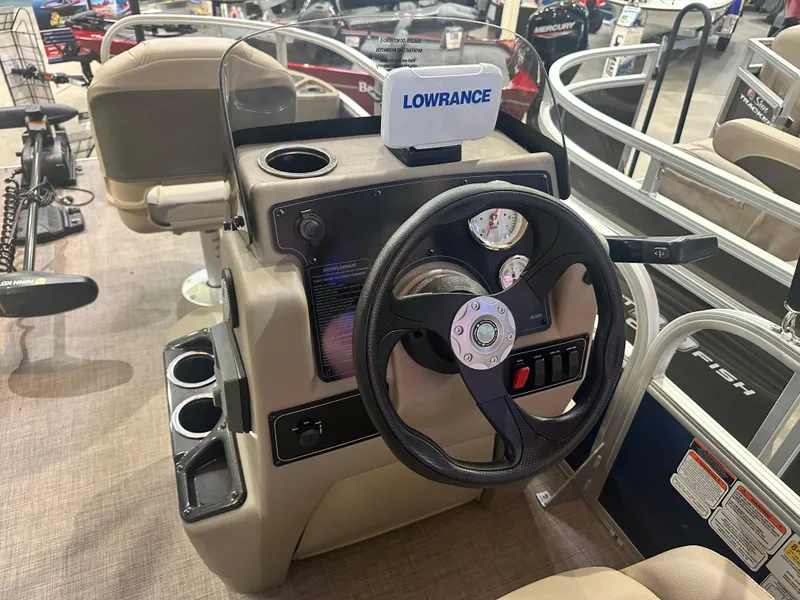 Slide: The Image of 2025 Sun Tracker Bass Buggy 18 DLX dashboard with Lowrance fish finder. - 2