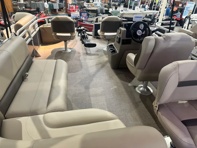 Slide: The Image of Interior view of 2025 Sun Tracker Bass Buggy 18 DLX pontoon boat with seating and steering console. - 3