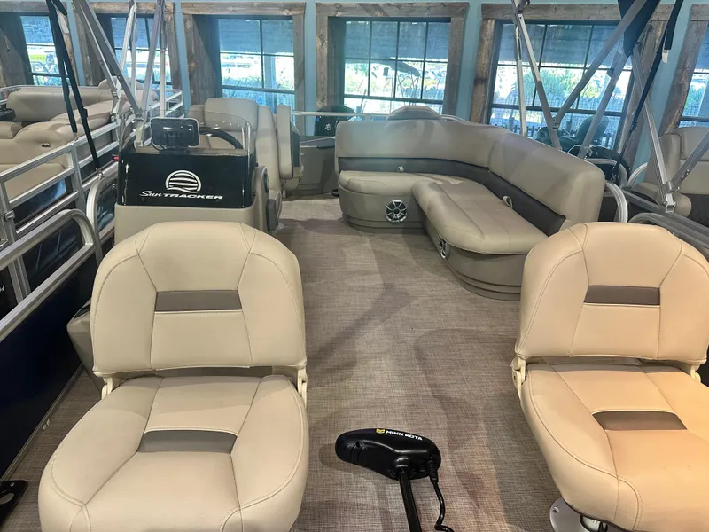 Slide: The Image of 2025 Sun Tracker Bass Buggy 18 DLX interior with beige seating and spacious layout. - 4