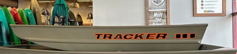 The Image of 2025 Tracker Grizzly 1036 Utility boat displayed in a showroom. - 0