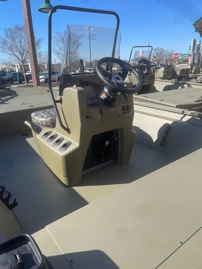 Slide: The Image of 2025 Tracker Grizzly 1860 CC boat with center console and steering wheel, docked outdoors. - 2