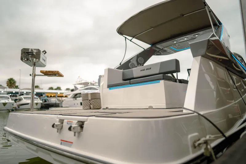 Slide: The Image of 2025 NHD 315 Open Deck boat with sleek design at marina. - 12