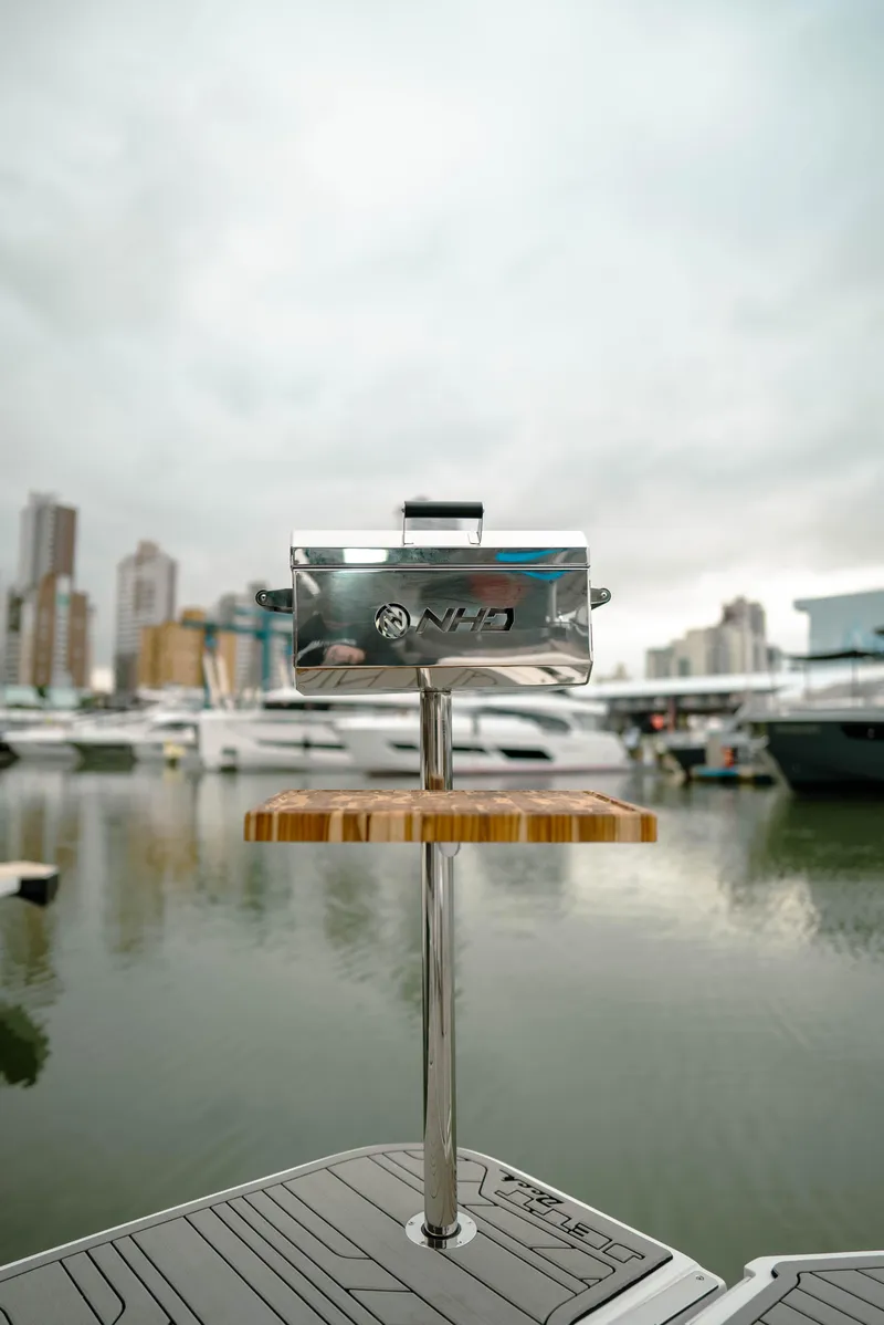 Slide: The Image of NHD 315 Open Deck 2025 boat with city skyline in background. - 14