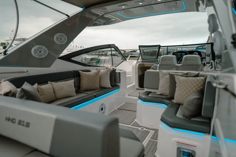 Slide: The Image of Luxurious 2025 NHD 315 Open Deck boat interior with modern seating and ambient lighting. - 16