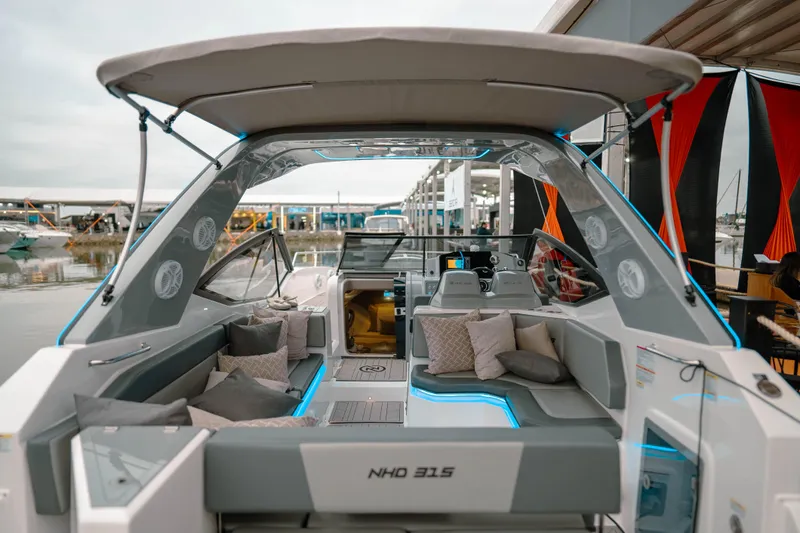 Slide: The Image of 2025 NHD 315 Open Deck boat with modern seating and canopy. - 18
