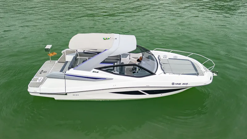 Slide: The Image of 2025 NHD 315 Open Deck boat on green water. - 2