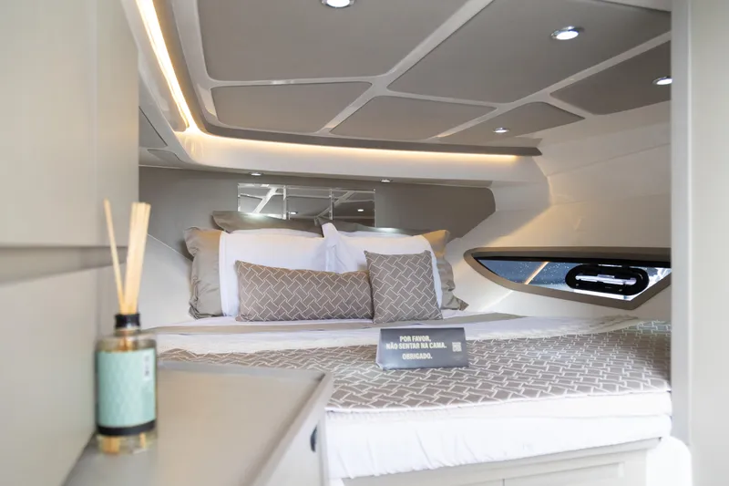 Slide: The Image of Luxurious interior of 2025 NHD 315 Open Deck boat with elegant bedding and ambient lighting. - 23