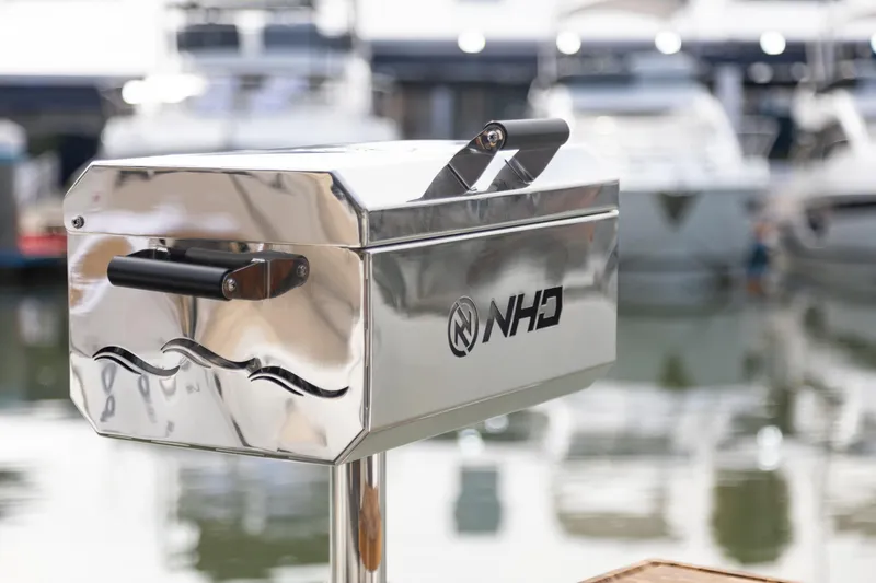 Slide: The Image of Stainless steel grill on NHD 315 Open Deck boat, 2025 model, docked at marina. - 28