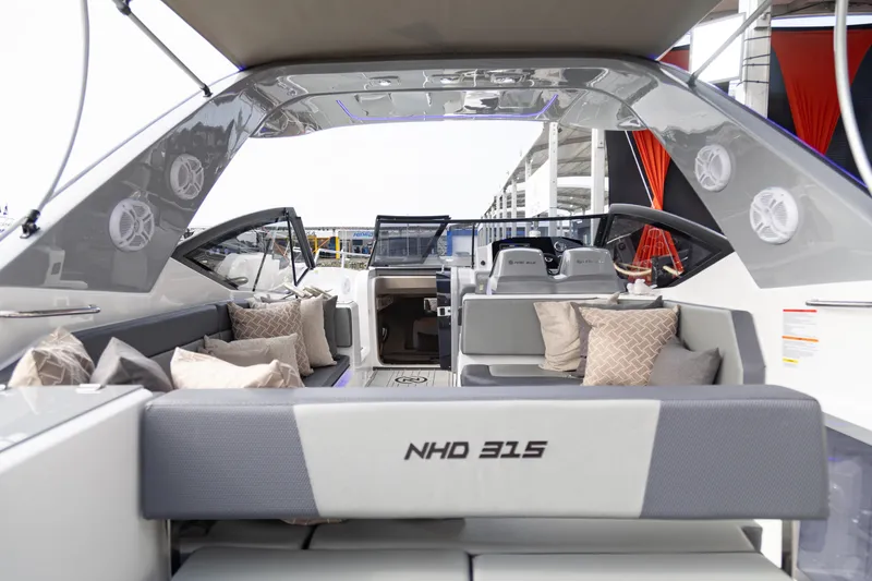 Slide: The Image of 2025 NHD 315 Open Deck boat interior with modern seating and cushions. - 29