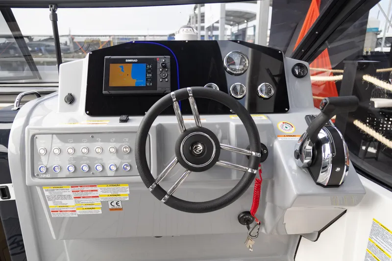 Slide: The Image of 2025 NHD 315 Open Deck boat helm with steering wheel and navigation system. - 36