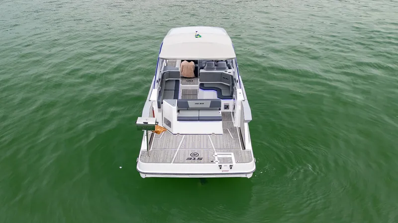 Slide: The Image of 2025 NHD 315 Open Deck boat on calm green water. - 4