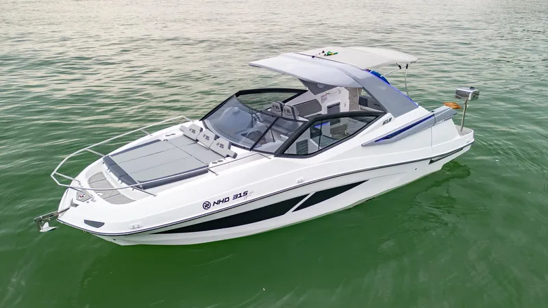 Slide: The Image of 2025 NHD 315 Open Deck boat on calm green water. - 6