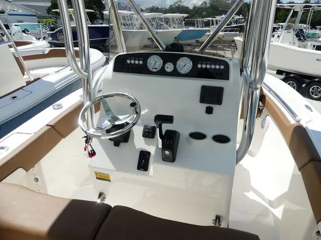 Slide: The Image of 2025 Pioneer Sportfish 202 boat console with steering wheel and controls. - 11