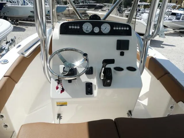 Slide: The Image of Pioneer Sportfish 2025 boat console with steering wheel and controls. - 12