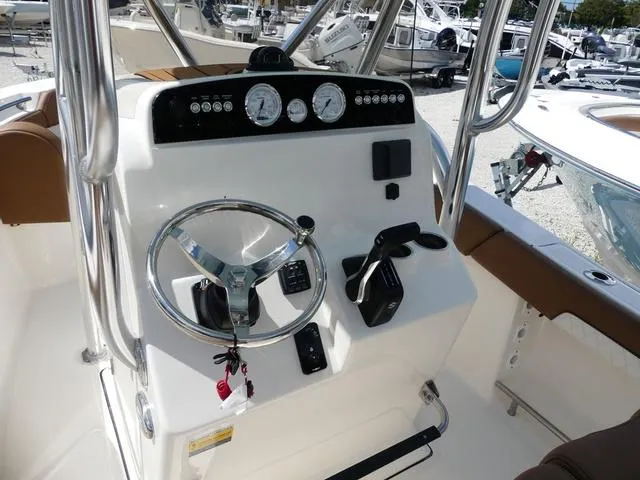 Slide: The Image of 2025 Pioneer Sportfish 202 boat seating with brown and white upholstery. - 13