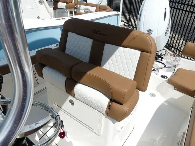 Slide: The Image of 2025 Pioneer Sportfish 202 boat interior with Suzuki engine and tan seating. - 14