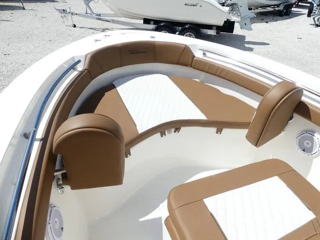 Slide: The Image of 2025 Pioneer Sportfish 202 boat with brown cushioned seating and white deck. - 16