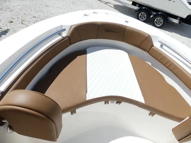 Slide: The Image of 2025 Pioneer Sportfish 202 boat interior with tan and white cushioned seating. - 17