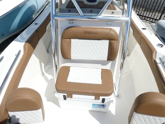 Slide: The Image of 2025 Pioneer Sportfish 202 boat interior with cushioned seating and stainless steel frame. - 18