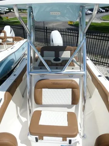 Slide: The Image of 2025 Pioneer Sportfish 202 boat interior with tan and white seating, stainless steel frame. - 19