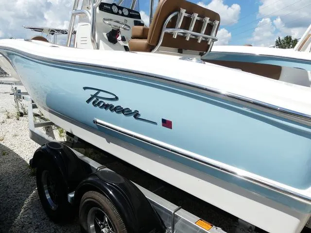 Slide: The Image of 2025 Pioneer Sportfish 202 boat with Suzuki engine, parked on a trailer under a clear sky. - 5