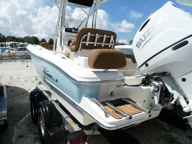 Slide: The Image of 2025 Pioneer Sportfish 202 boat with powerful outboard motor, docked under a cloudy sky. - 6