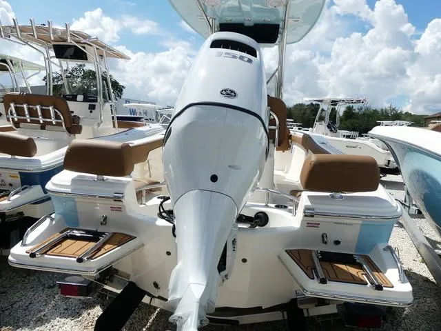Slide: The Image of 2025 Pioneer Sportfish 202 boat with powerful outboard motor, docked under a sunny sky. - 7