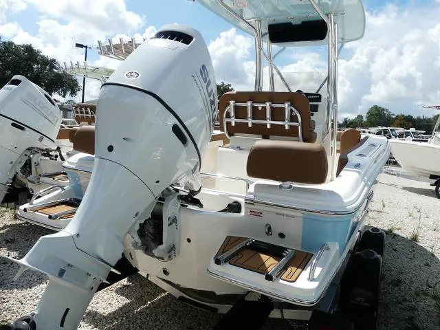Slide: The Image of 2025 Pioneer Sportfish 202 boat with Suzuki outboard motor and brown seating. - 8