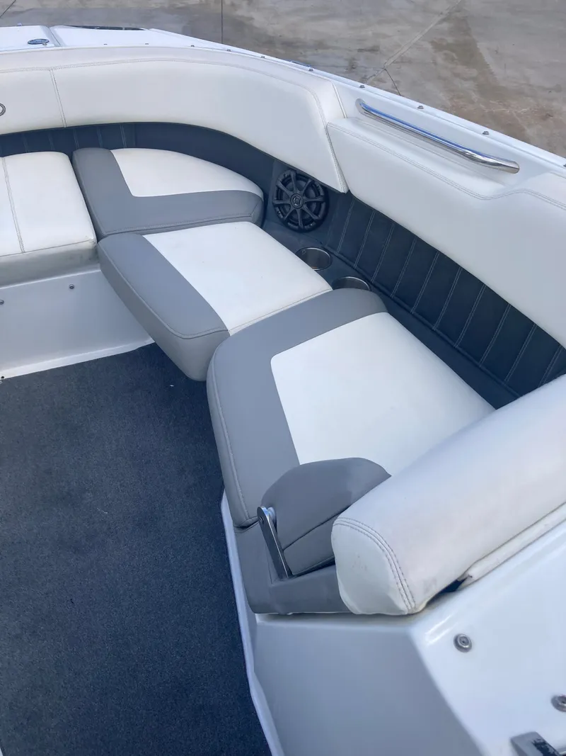 Slide: The Image of 2013 Cobalt 24SD boat interior with gray and white seating. - 10
