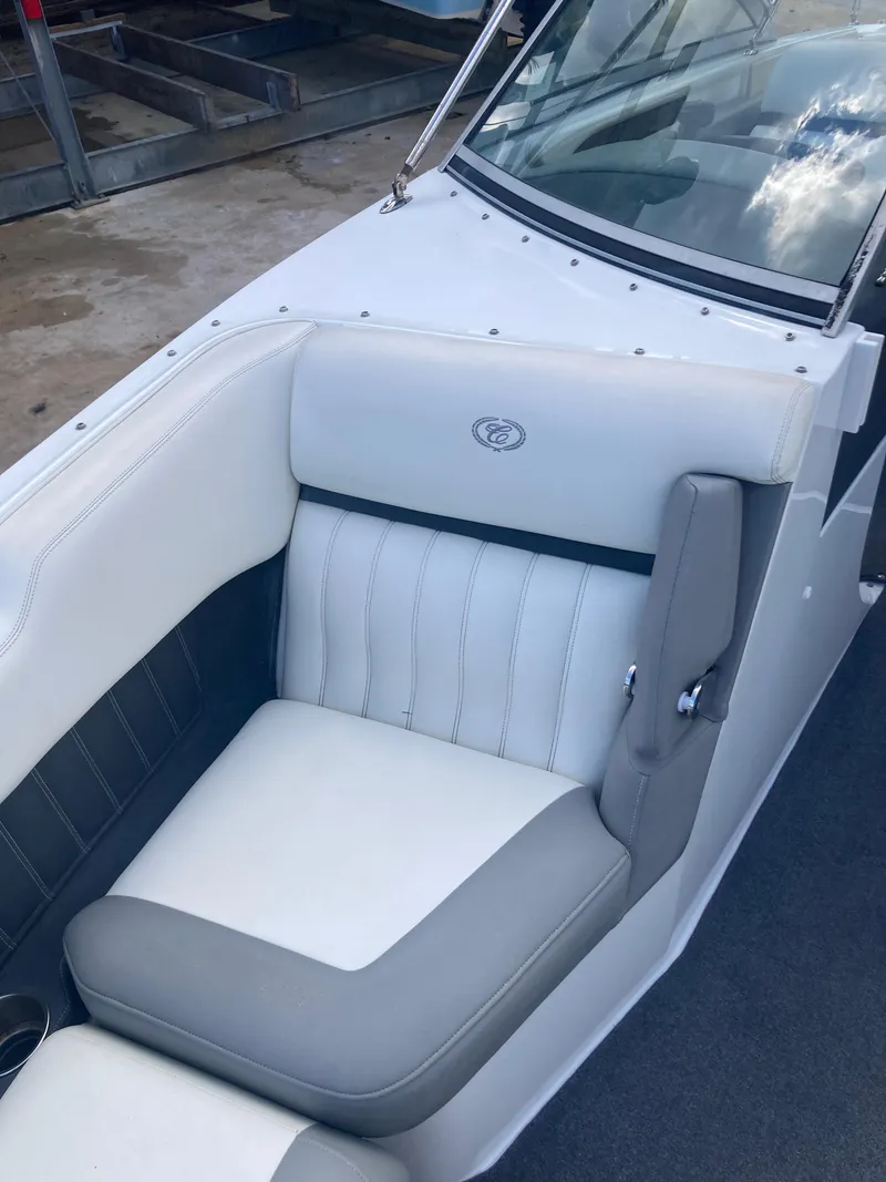 Slide: The Image of 2013 Cobalt 24SD boat interior with white and gray seating. - 11