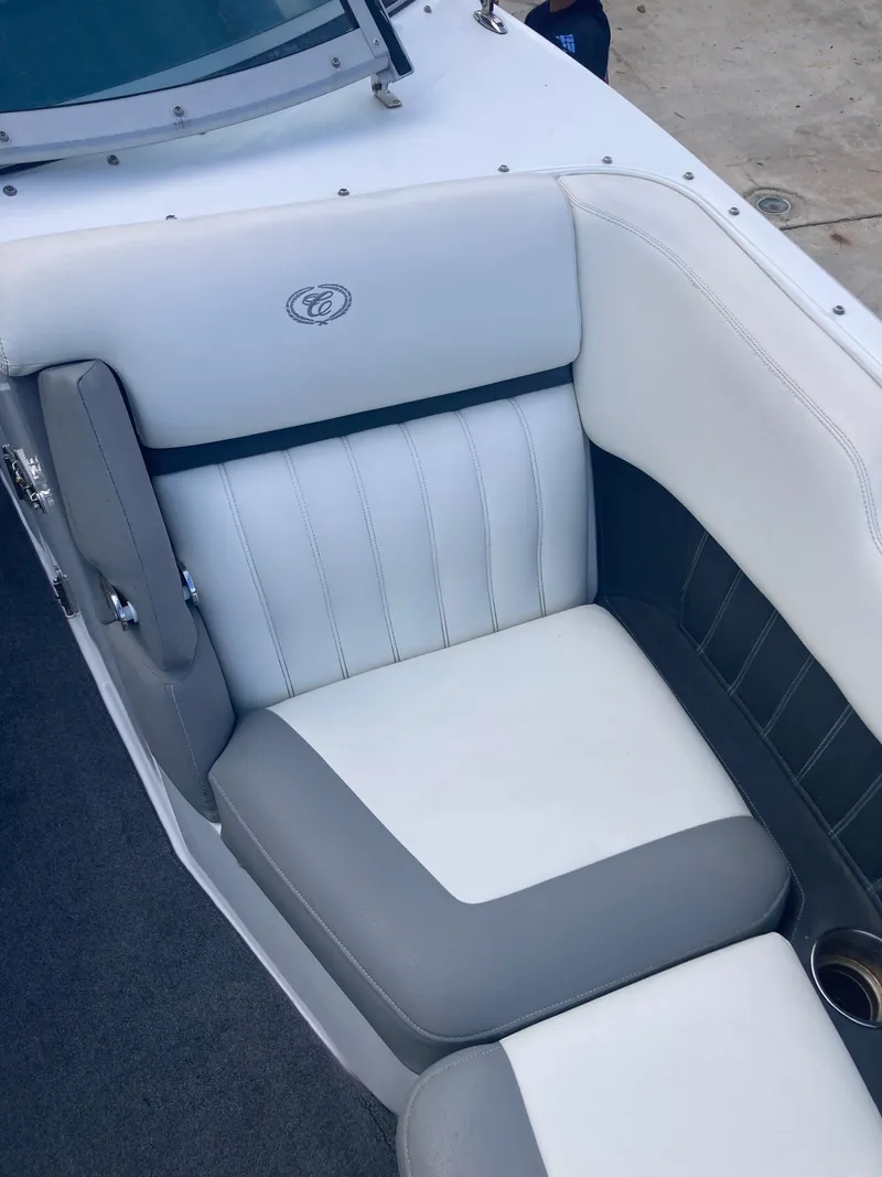 Slide: The Image of 2013 Cobalt 24SD boat interior with white and gray seating. - 12