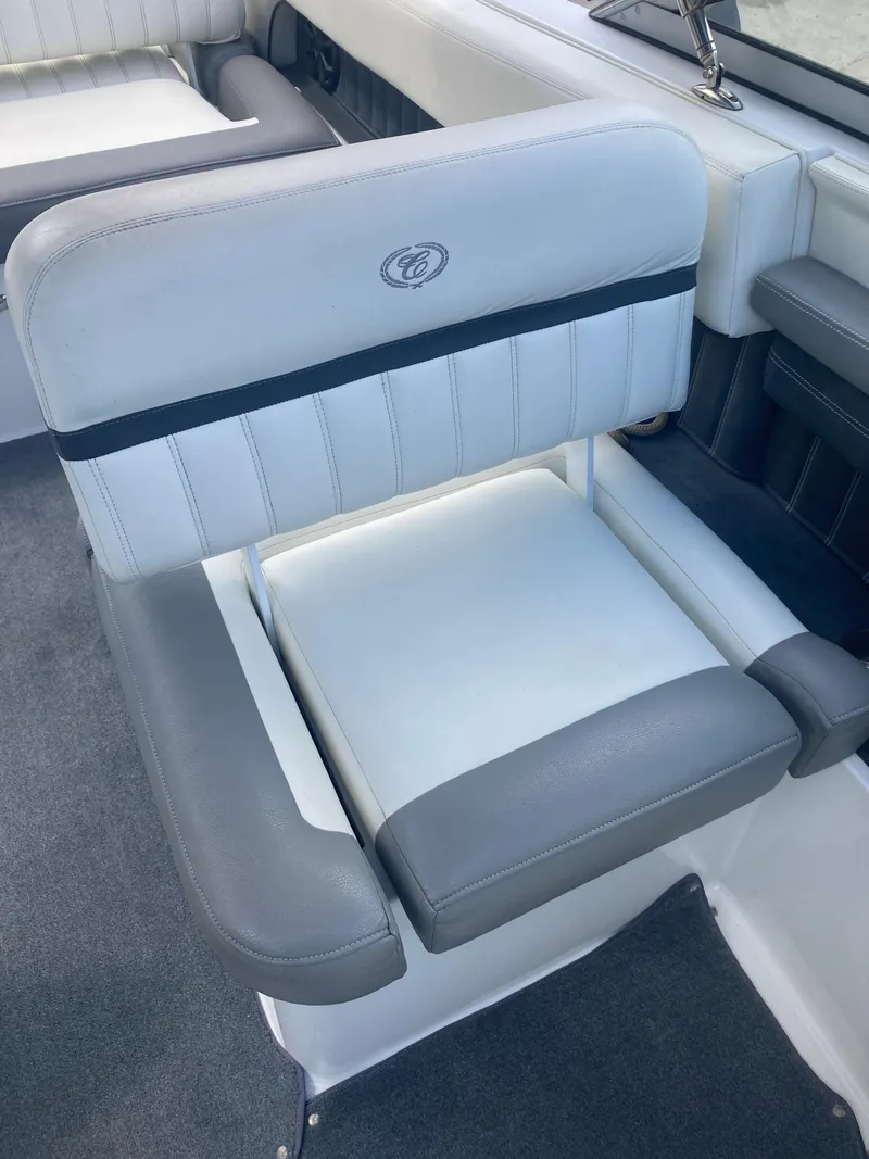 Slide: The Image of 2013 Cobalt 24SD boat seat with gray and white upholstery. - 18