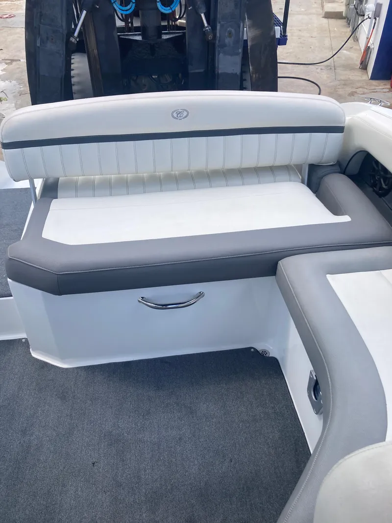 Slide: The Image of 2013 Cobalt 24SD boat interior with white and gray seating. - 21