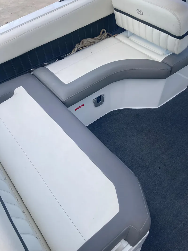Slide: The Image of 2013 Cobalt 24SD boat interior with white and gray seating. - 25