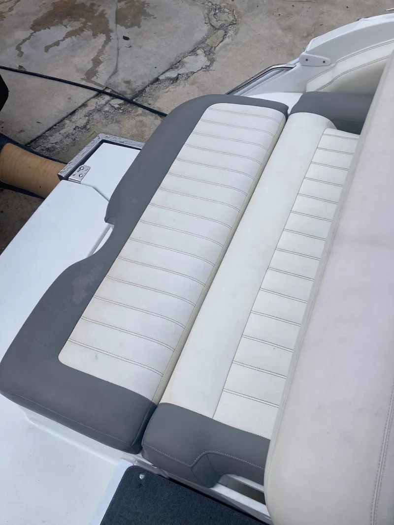 Slide: The Image of 2013 Cobalt 24SD boat seat with white and gray upholstery. - 27