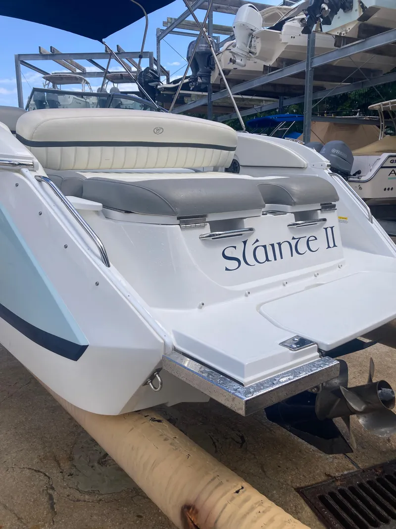 Slide: The Image of 2013 Cobalt 24SD boat, rear view, named "Sláinte II," on a trailer. - 7